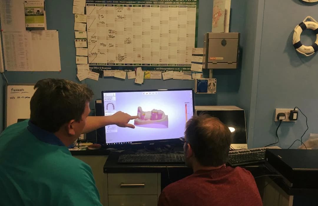 Wessex technicians reviewing a case on the design screen at the Poole bench